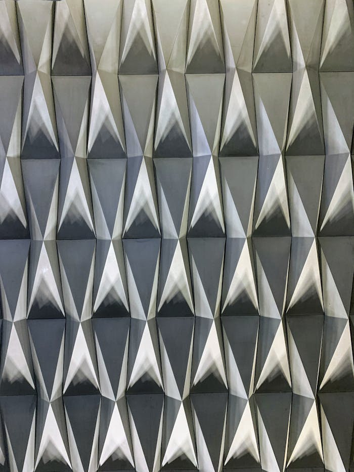 Abstract geometric silver panel with a modern metallic aesthetic and symmetrical design.